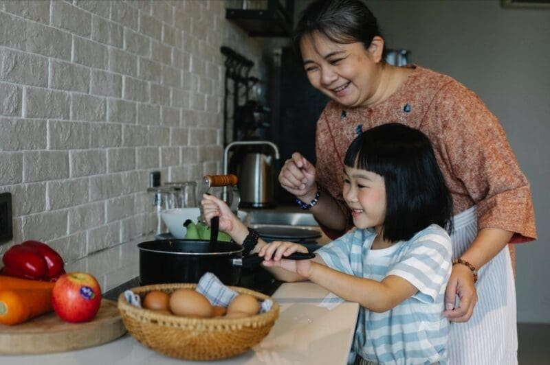 Woman and child cooking 