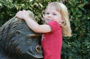 Little girl with a Brass Gorilla Safari Park