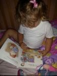 Little girl reading Rufus and Ryan go to Church kids book