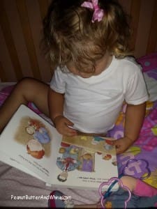 Little girl reading Rufus and Ryan go to Church kids book