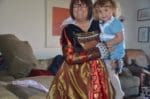 Woman in Queen of Hearts adult Costume holding little girl in Alice in Wonderland costume