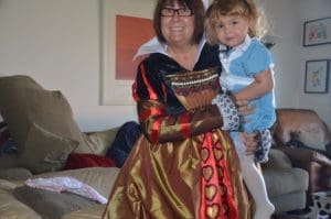 Woman in Queen of Hearts adult Costume holding little girl in Alice in Wonderland costume