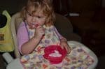 little girl in a no mess bib