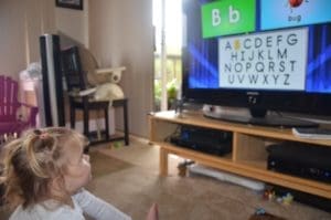 little girl watching Letter sounds DVD