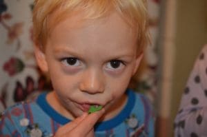 Little boy using Dentek flosser