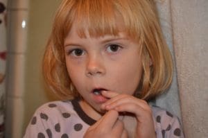 Little girl using Dentek flosser