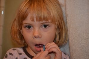 Little girl using Dentek flosser