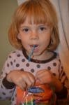 Little girl using Dentek flosser