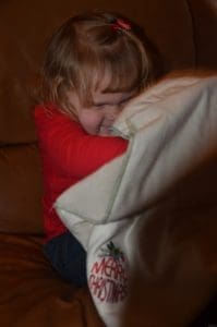 Little girl with her Organic Caboose Throw