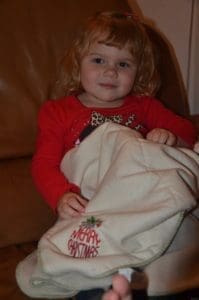 Little girl with her Organic Caboose Throw