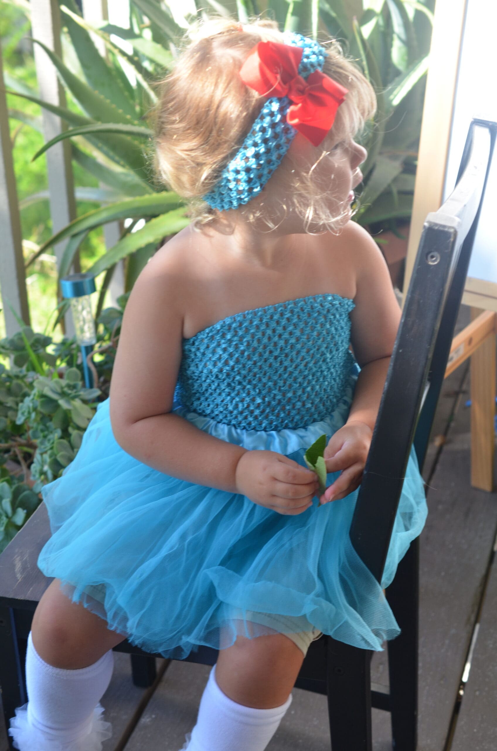 Cute little girl in a headband with a red flower