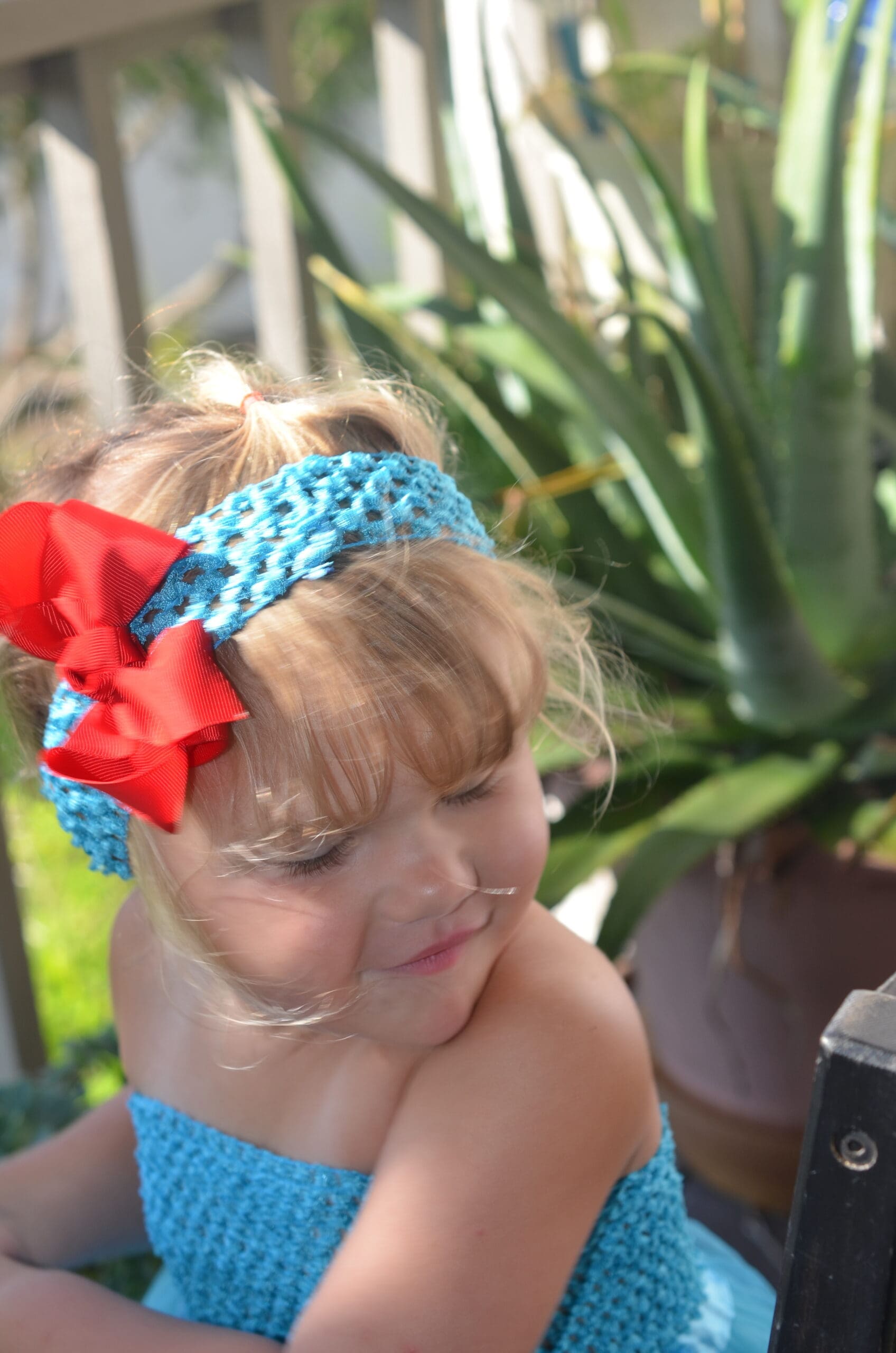 Cute little girl in a headband with a red flower