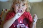 Little girl covered in ice cream