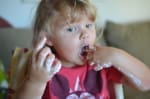Little girl covered in ice-cream