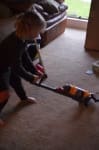 Little girl using her Pretend Dyson Vacuum for Kids