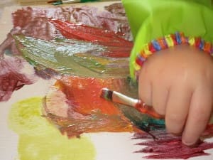 Little girls hand while painting