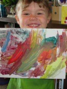 Little girl holding her painting