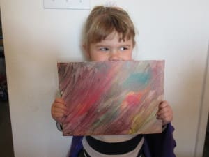 little girl holding her painting