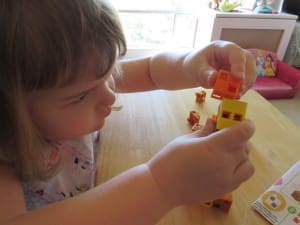 Little girl playing Click-A-Brick Set