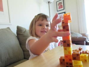 Little girl playing Click-A-Brick Set