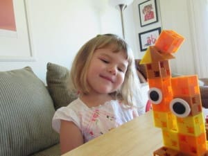 Little girl playing Click-A-Brick Set