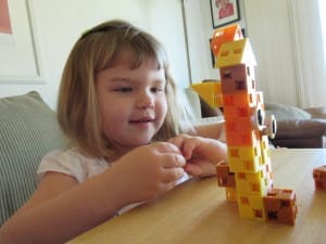 Little girl playing Click-A-Brick Set