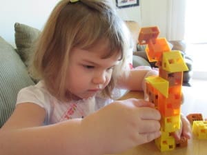 Little girl playing Click-A-Brick Set