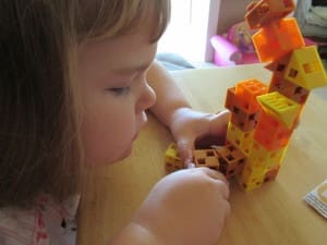 Little girl playing Click-A-Brick Set