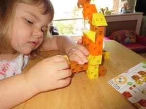 Little girl playing Click-A-Brick Set