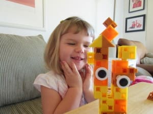 Little girl playing Click-A-Brick Set