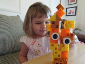 Little girl playing Click-A-Brick Set