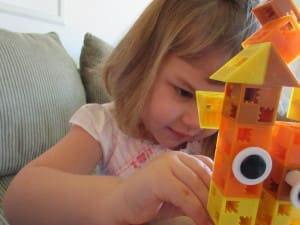 Little girl playing Click-A-Brick Set