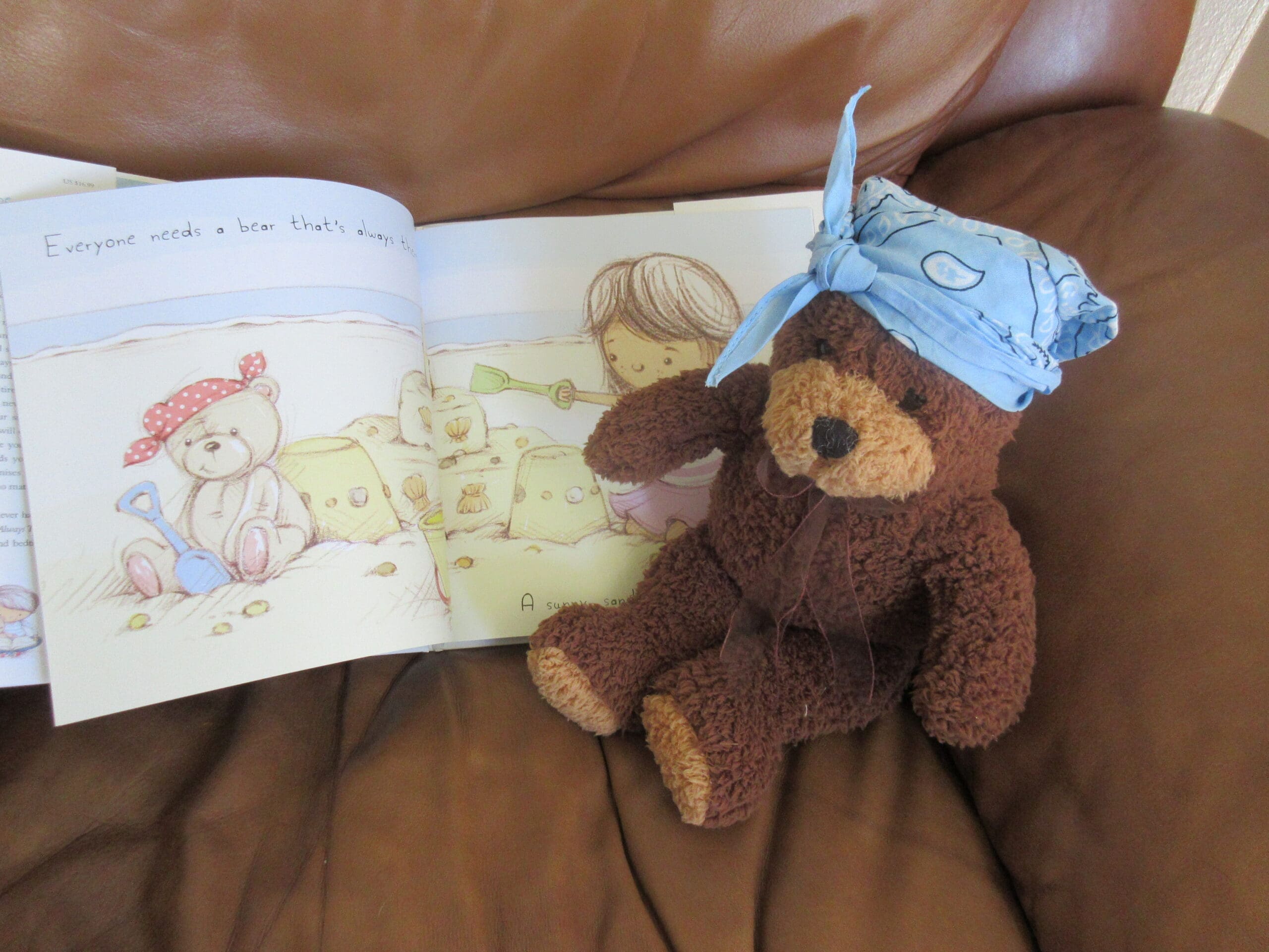 Little girl with book and teddy bear