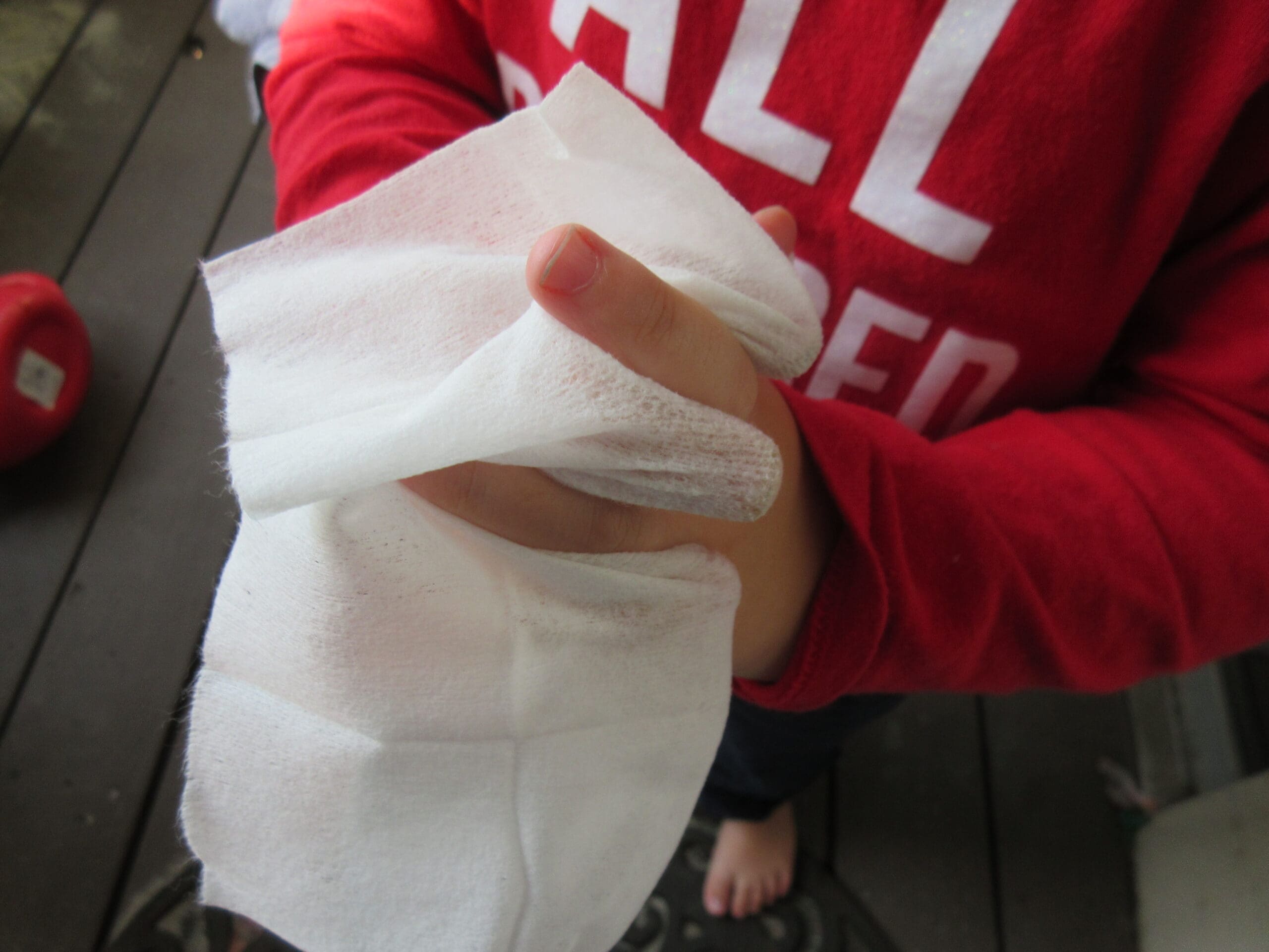 child using a wet wipe