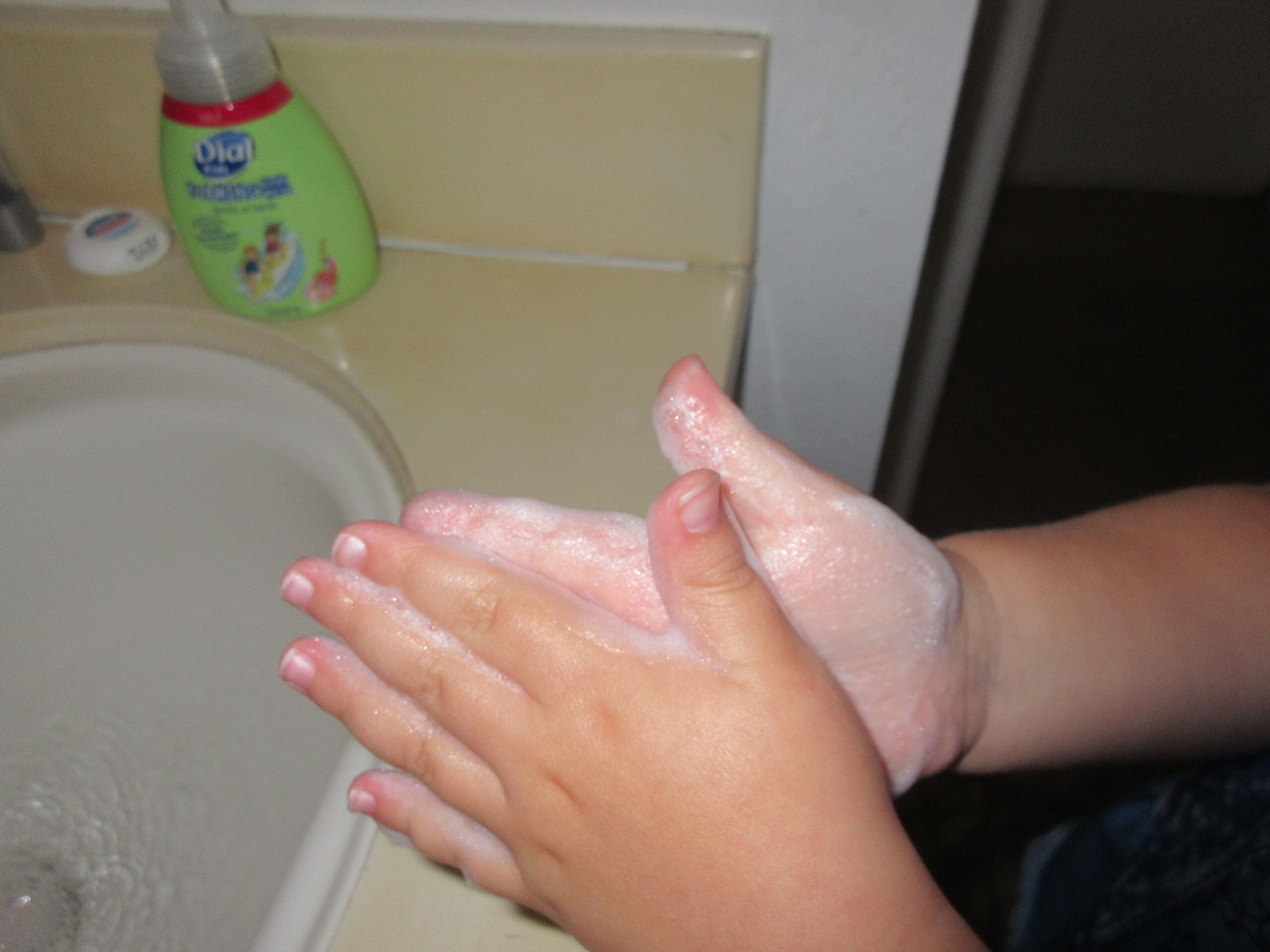 Little girl washing hands