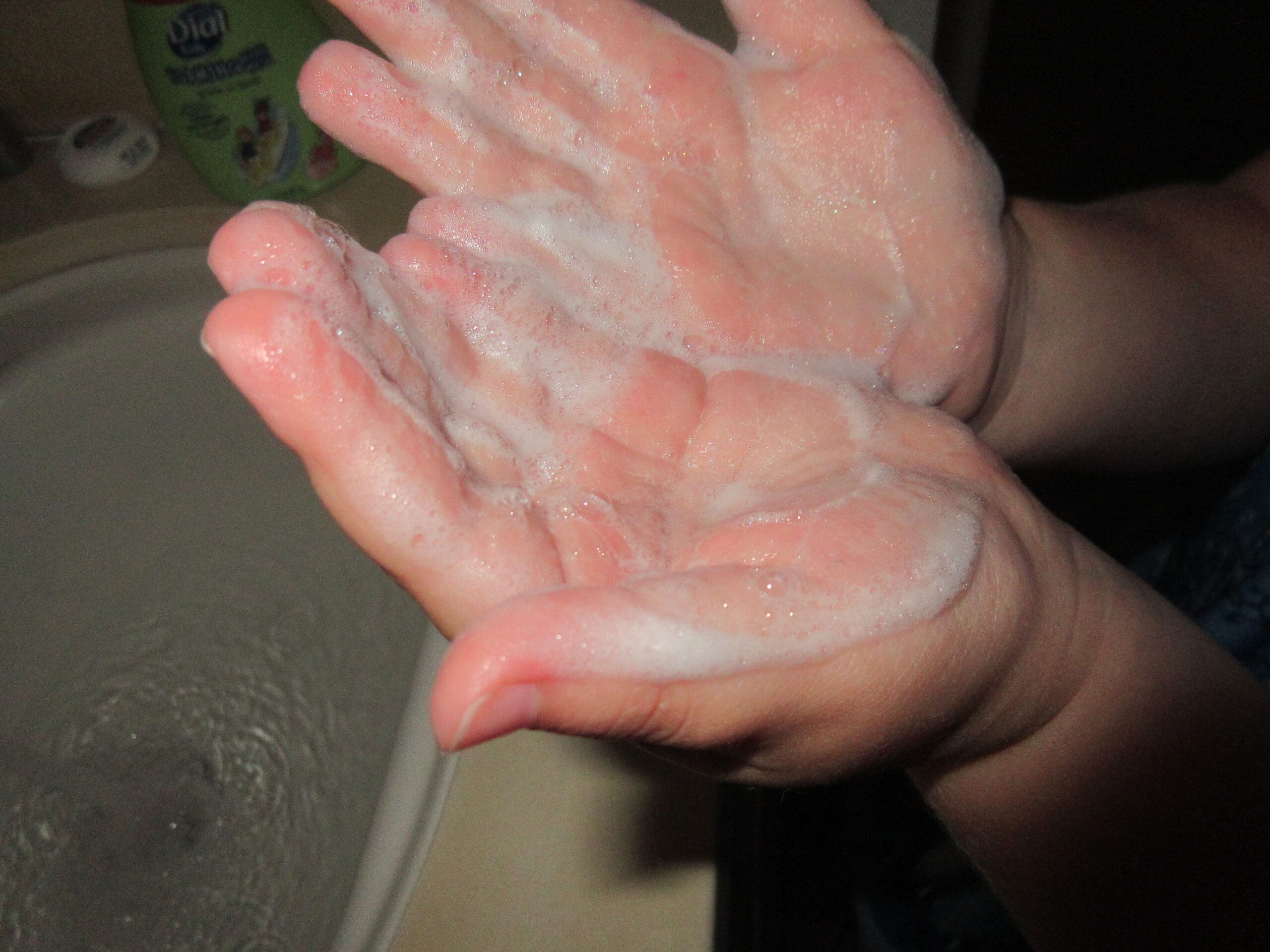 Little girl washing hands