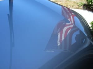 reflection of Flag in car window
