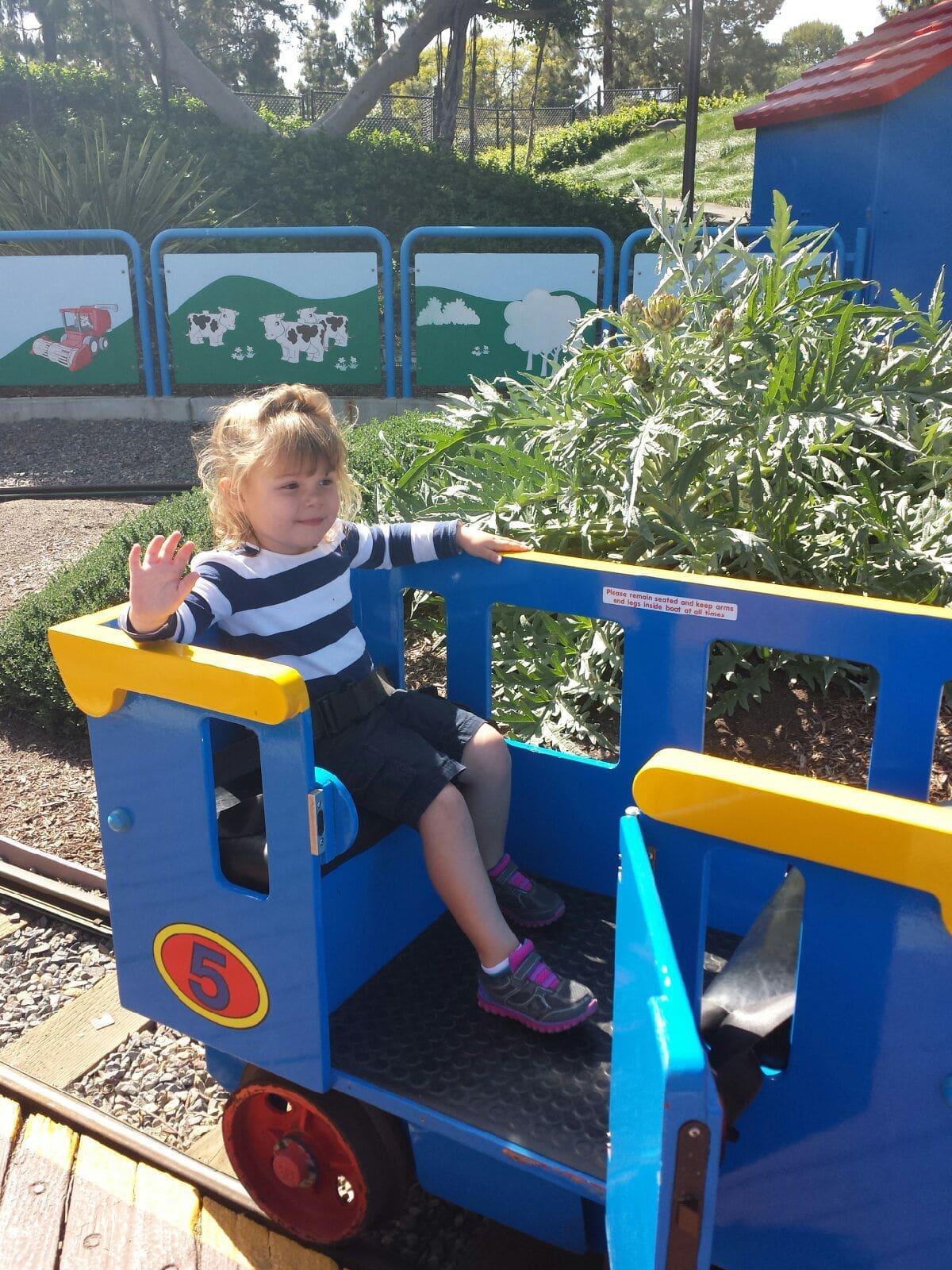 little riding a mini train at legoland CA