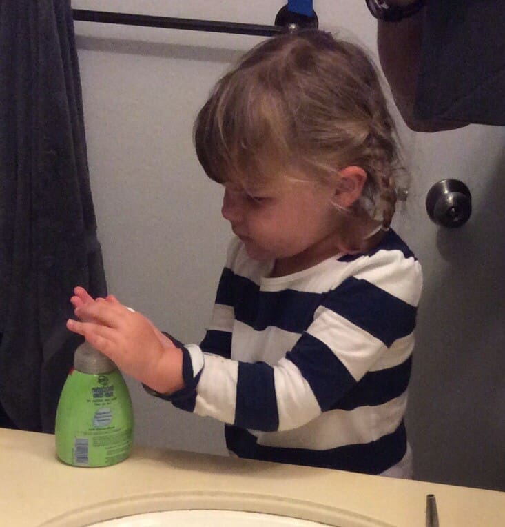 Little girl washing hands