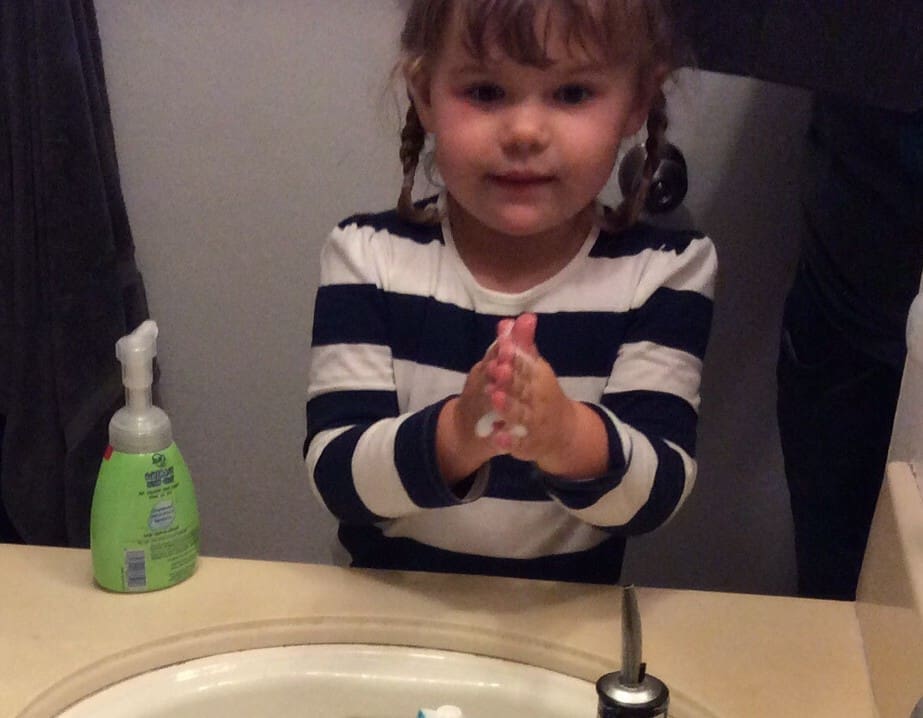 Little girl washing hands