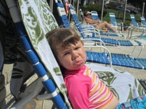 Little girl at the pool with pouty face