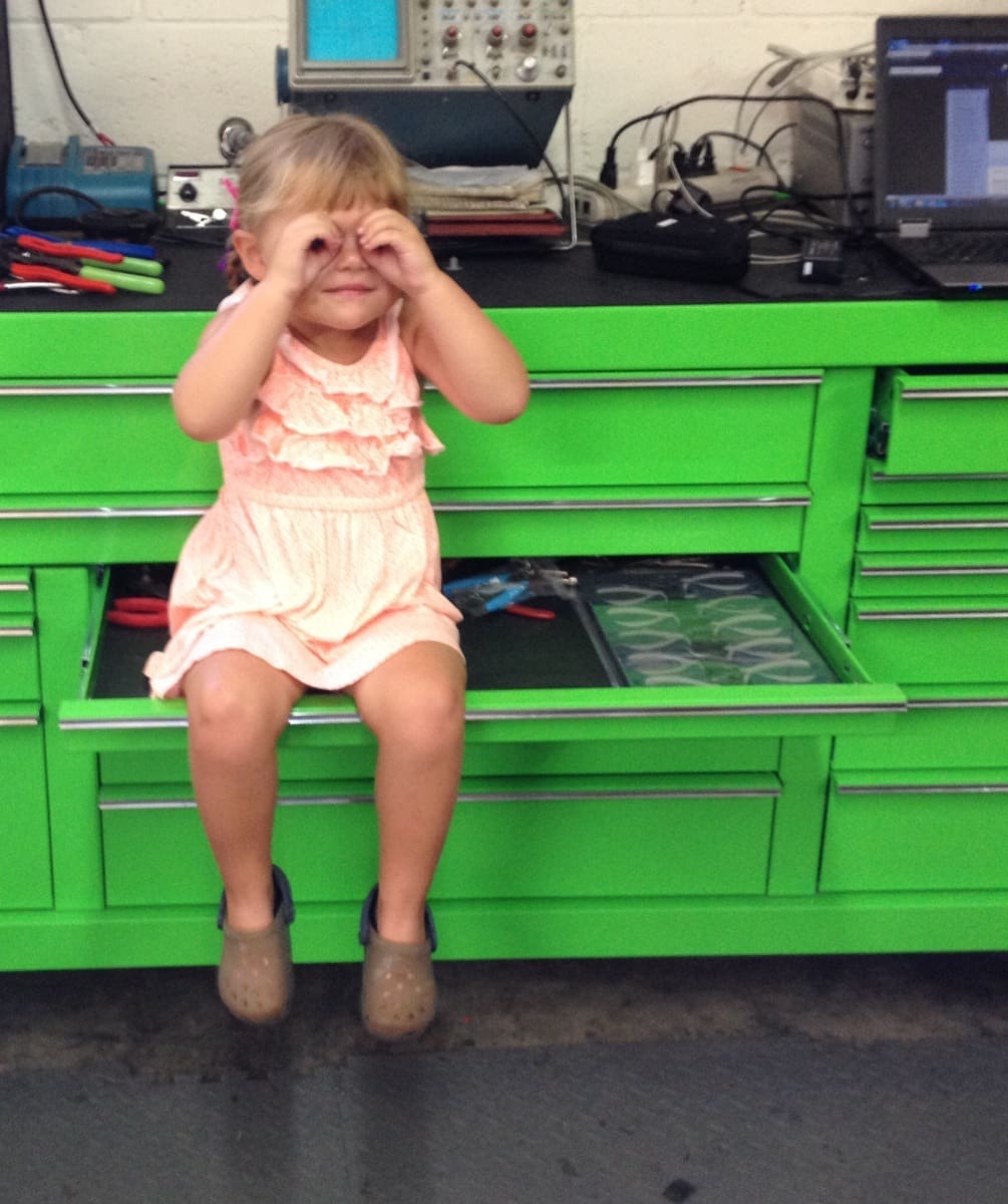 Little girl on a tool box