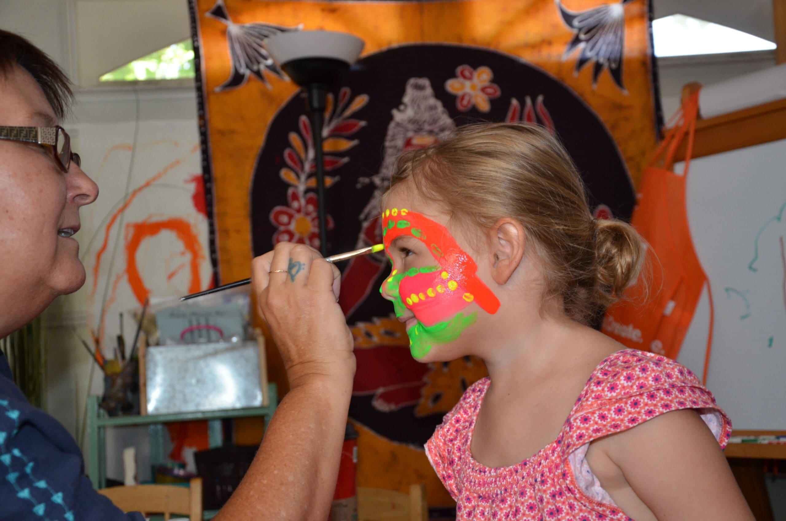 Little girl in neon face paint