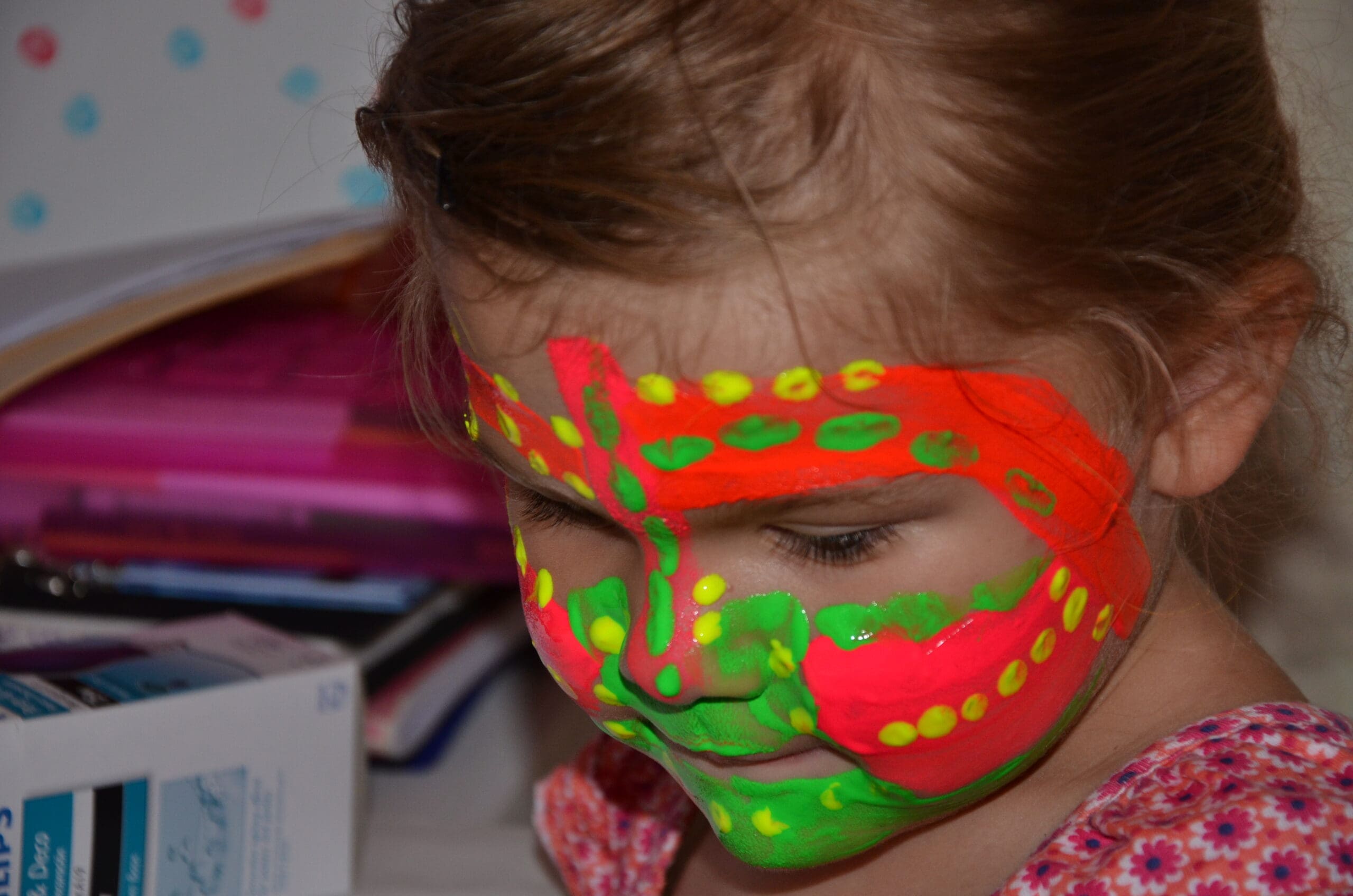 Little girl in neon face paint