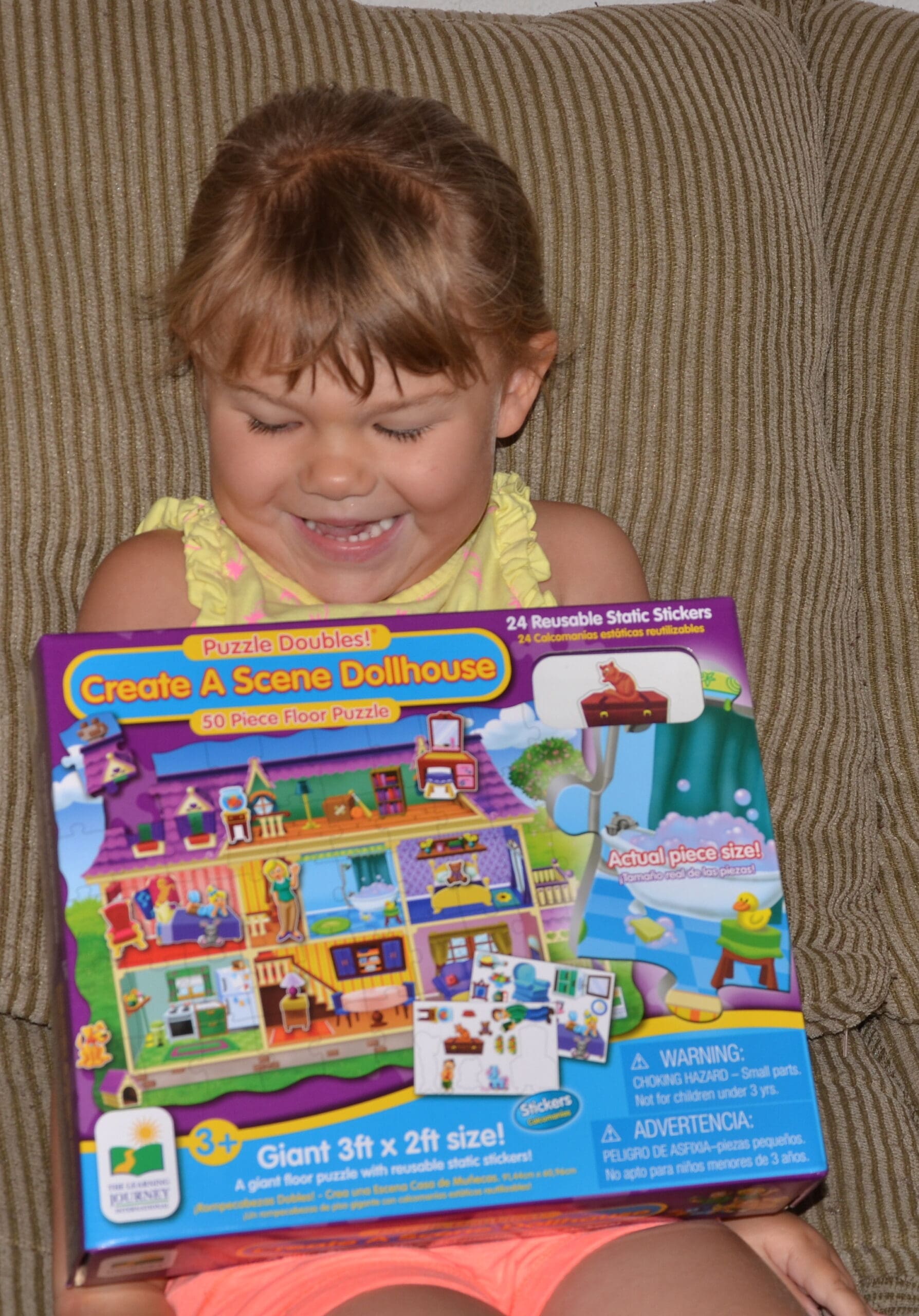 smiling girl with her new dollhouse puzzle