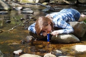 woman drinking from personal water filter