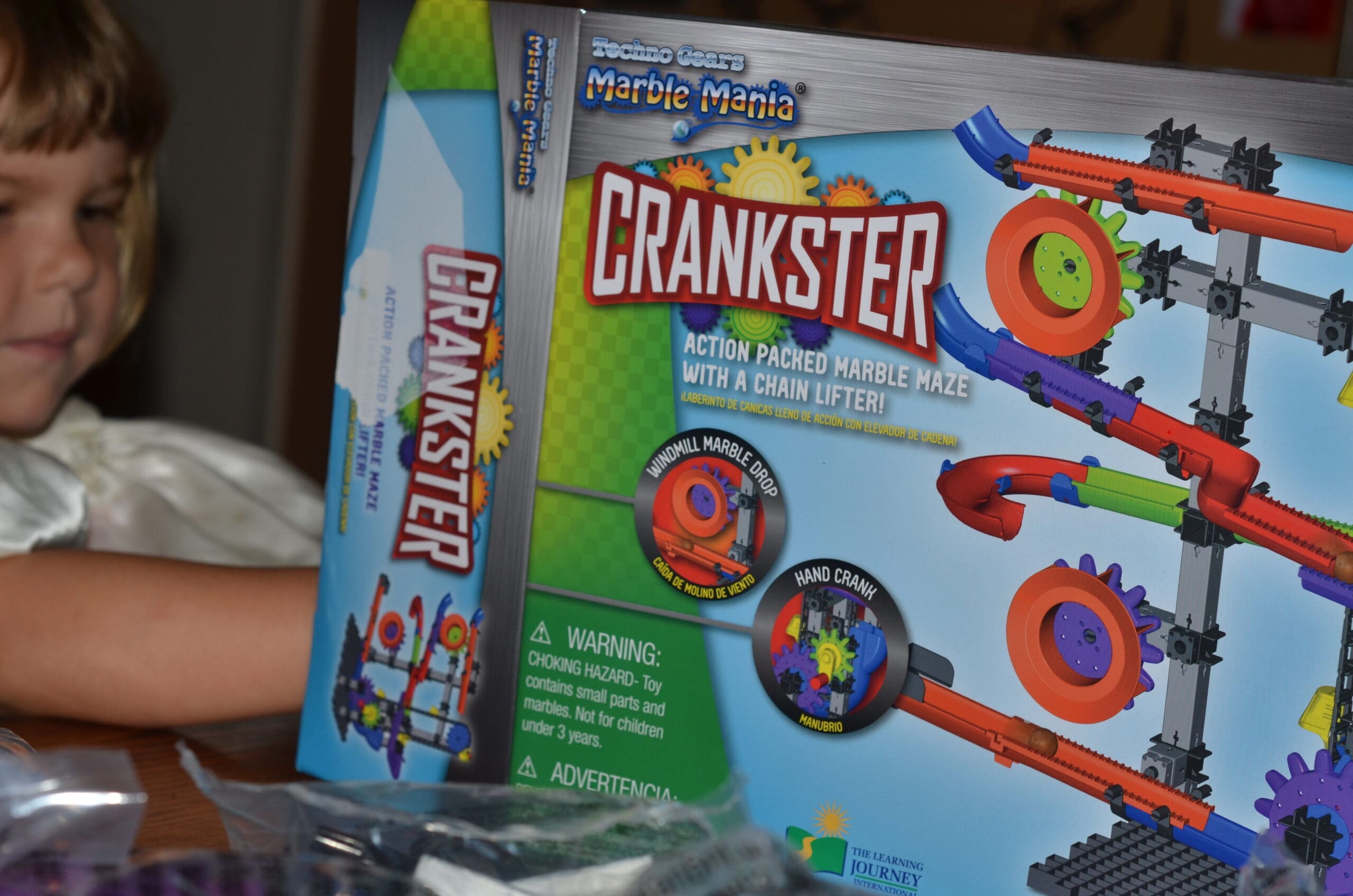 Marble Mania Crankster Little girl looking the marble mania crankster toy box