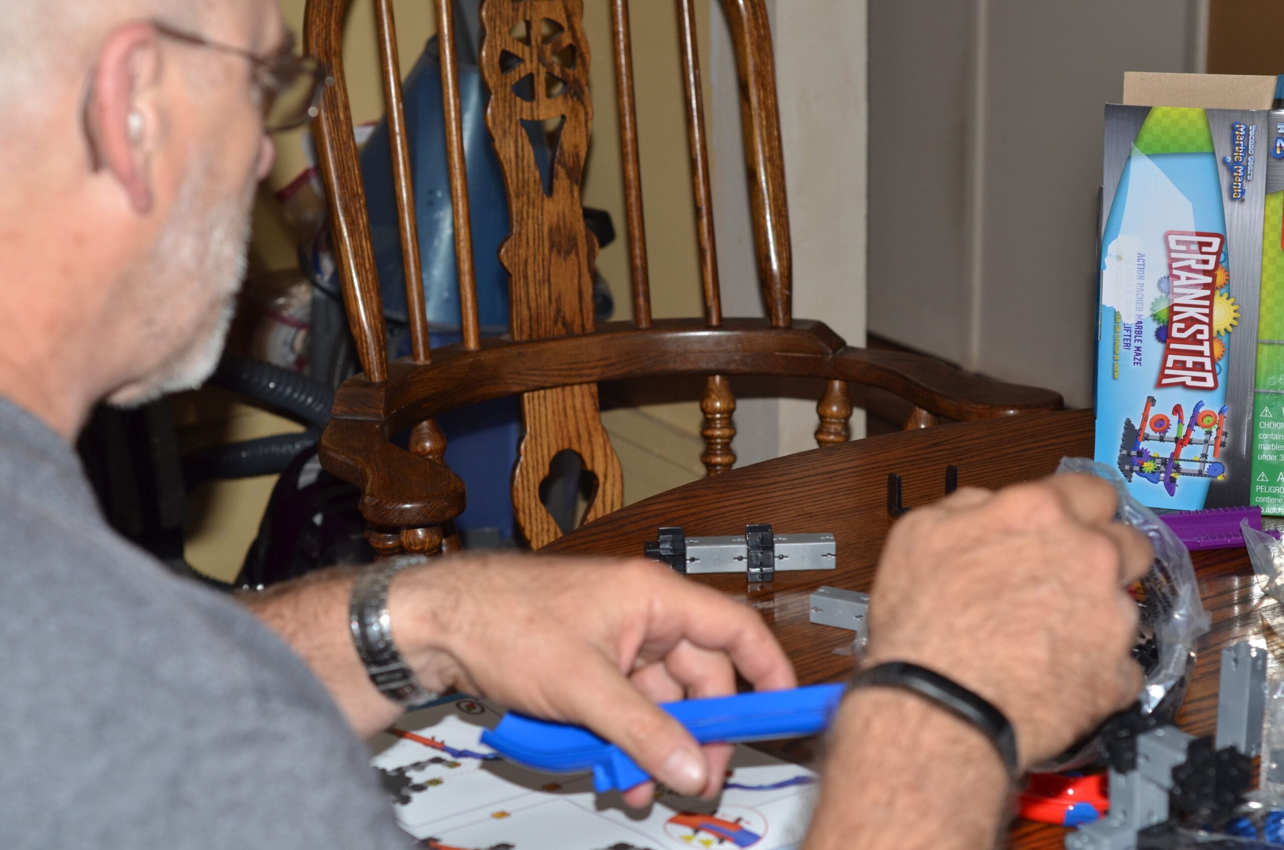 Marble Mania Crankster Grandpa putting together the marble mania crankster toy
