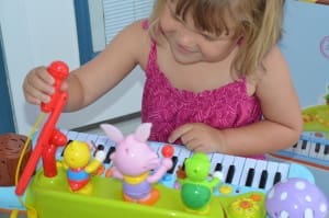little girl playing electronic musical organ