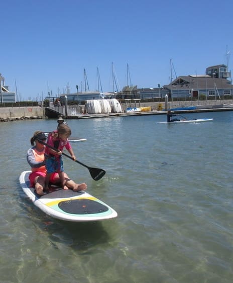 Mom and daugther on paddle board